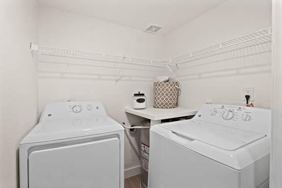 A small laundry room with a washer and dryer.