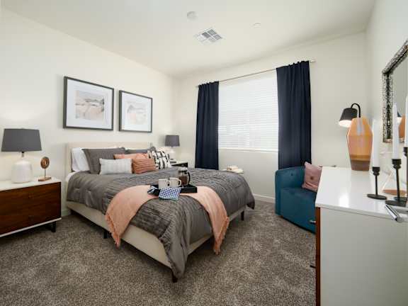 A bedroom with a large bed and a nightstand.