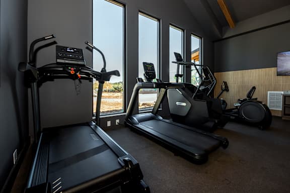 A home gym with treadmills, elliptical machines, and a stationary bike at The Crossings  at Windsong, Prescott Valley, 86314
