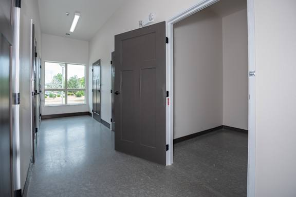 A room with a grey floor and a grey door at The Crossings  at Windsong, Prescott Valley, 86314