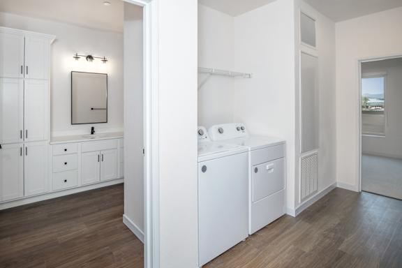 A bathroom with a washer and dryer in it.