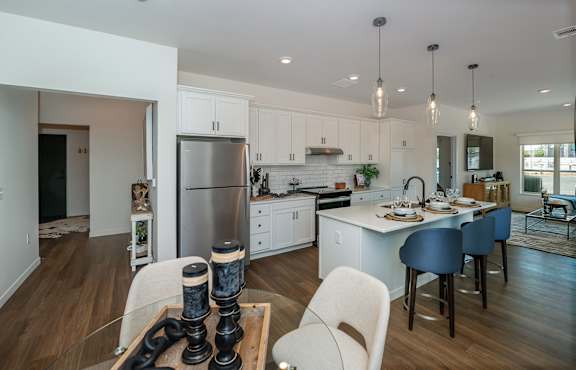 A modern kitchen with white cabinets and a large island.
