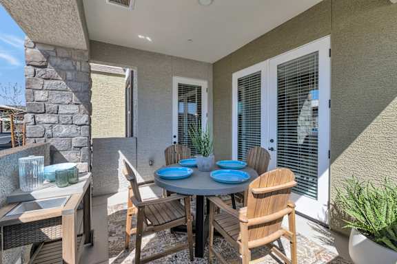 A patio with a table and chairs.
