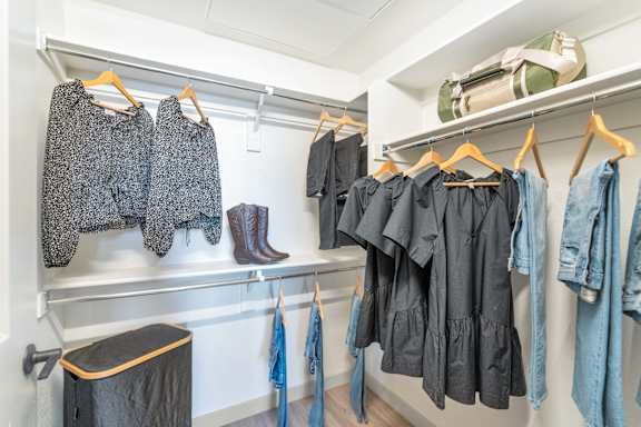 Clothes hanging on a rack in a room.