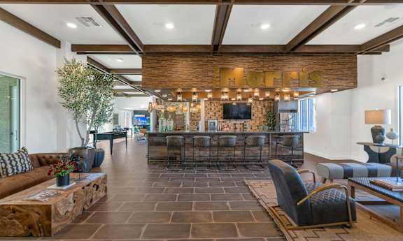 A living room with a stone floor and a fireplace.
