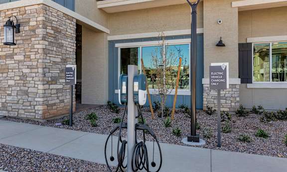 A bicycle is parked next to a charging station for electric vehicles.