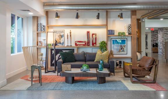 A modern living room with a grey couch and a coffee table.