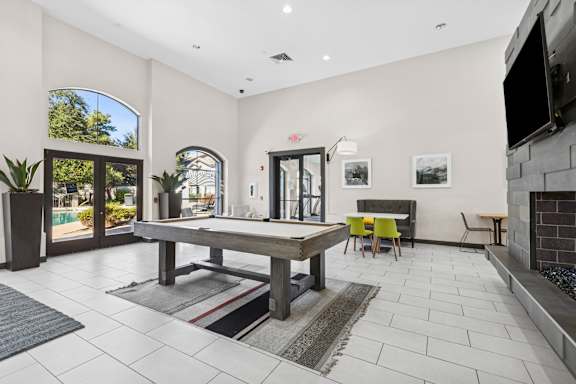 A modern living room with a fireplace and a dining table.