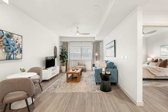 A living room with a brown chair and a blue couch.
