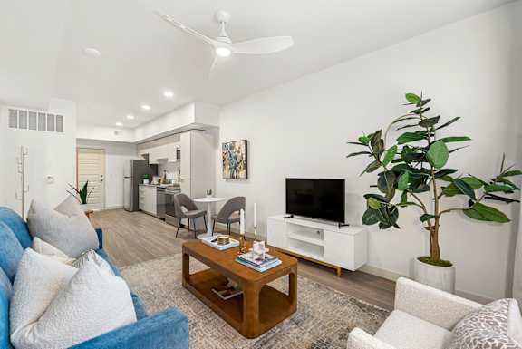 A living room with a blue couch and a television.