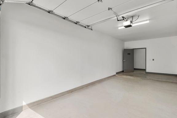Empty garage interior with automatic door opener at Lucero Apartments, Phoenix, AZ