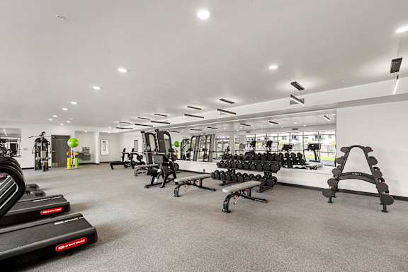 Fitness center with cardio and strength training equipment at Lucero Apartments, Arizona