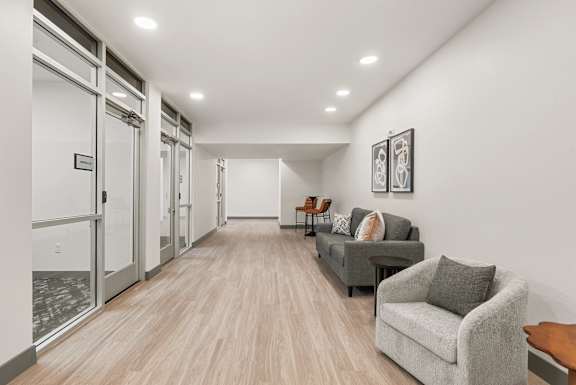 Modern lobby hallway with comfortable seating areas at Lucero Apartments, Phoenix, AZ