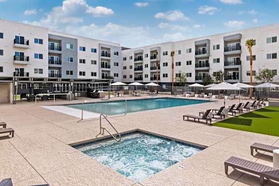 Outdoor pool and spa with lounge seating at Lucero Apartments, Phoenix, 85051