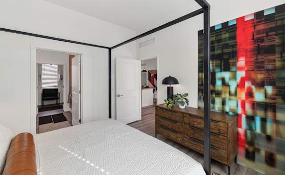 A bedroom with a large bed and a dresser.at Marketside Villas at Verrado, Buckeye, 85396