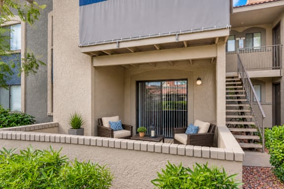 A modern house with a patio and a staircase.