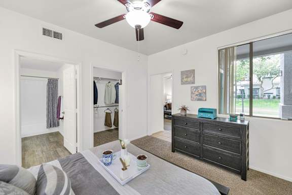 A bedroom with a bed, dresser, and mirror.