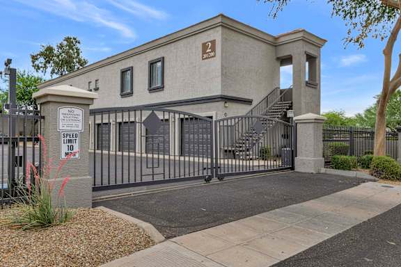 A building with a gate that has a sign on it.