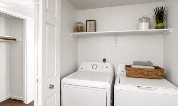 A small laundry room with a washer and dryer.