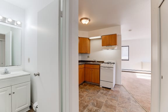 Kitchen With Bathroom View at Johnson Legacy Apartments, Milwaukee, 53223