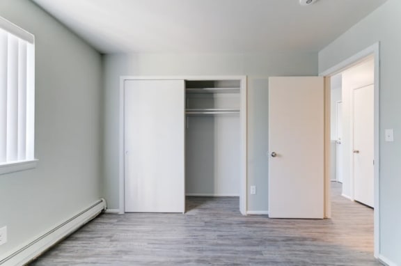 a bedroom with gray walls and white trim