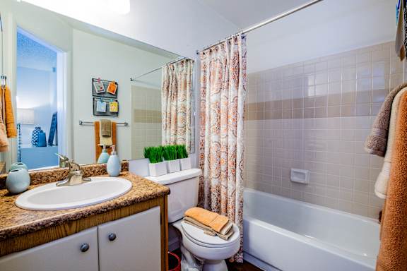A bathroom with a toilet, sink, and bathtub.