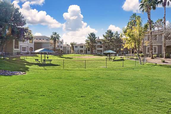 A grassy field with a soccer goal in the middle of it.