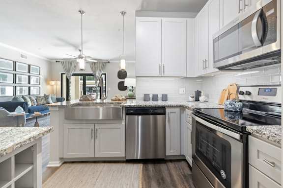 A modern kitchen with a stainless steel dishwasher and oven.