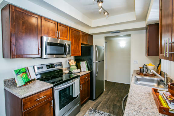 full kitchen with stainless steel appliances and granite counter tops at the reserve at south coast