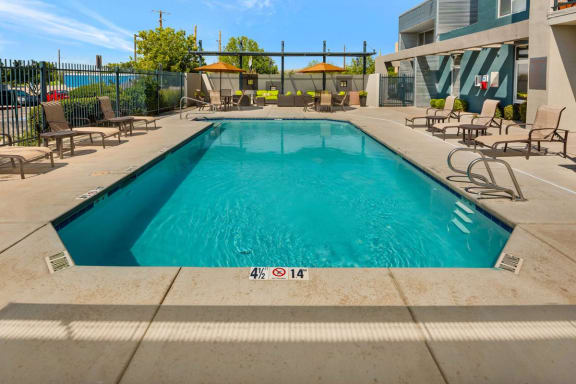 Resort Style Pool with Sun Deck and Lounge Chairs at ABQ Apartments