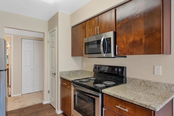Full Kitchen with Wood Cabinets at La Mirage Apartments