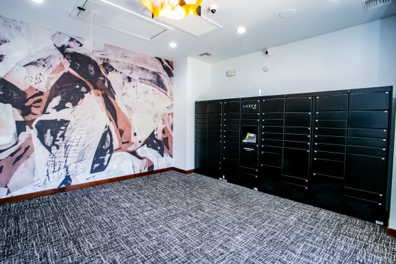 Apartments with secure package receiving lockers and a mural on the wall