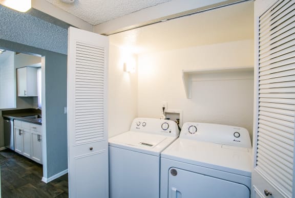a laundry room with two washes and a dryer in it