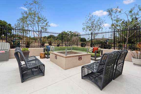 Two black chairs are placed on a patio.
