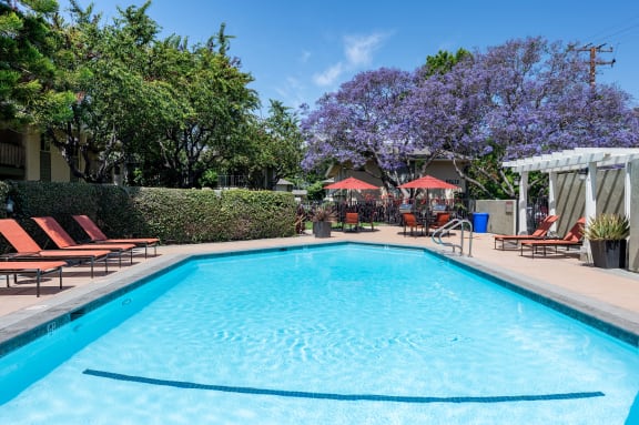 a swimming pool in front of a resort style pool
