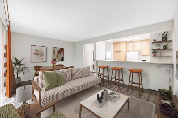 a living room with a couch and a kitchen with a bar