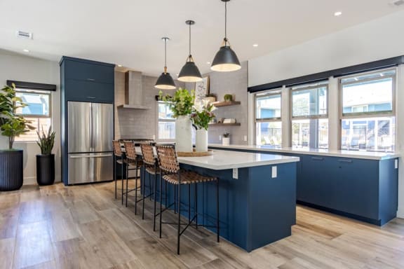 a large kitchen with blue cabinets and a white counter top