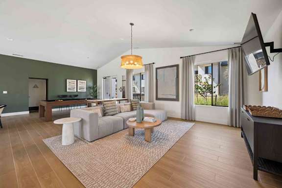A living room with a grey sofa and a wooden coffee table.