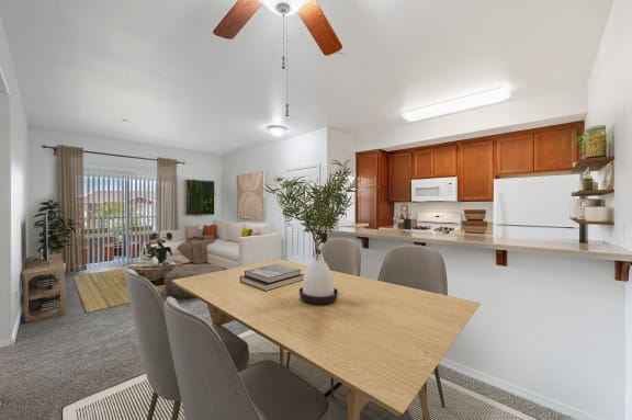 a living room and dining room with a table and chairs