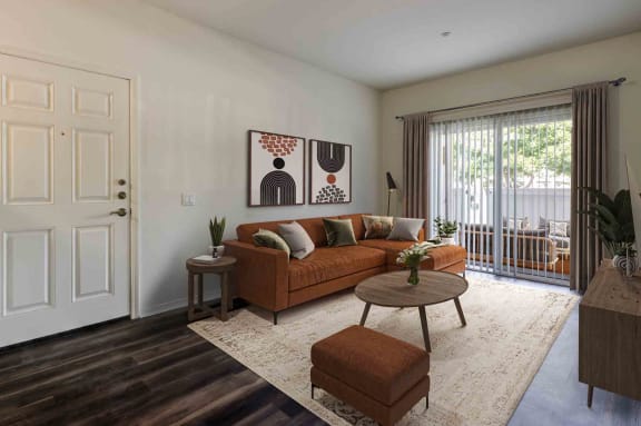 a living room with a couch and a table in front of a window