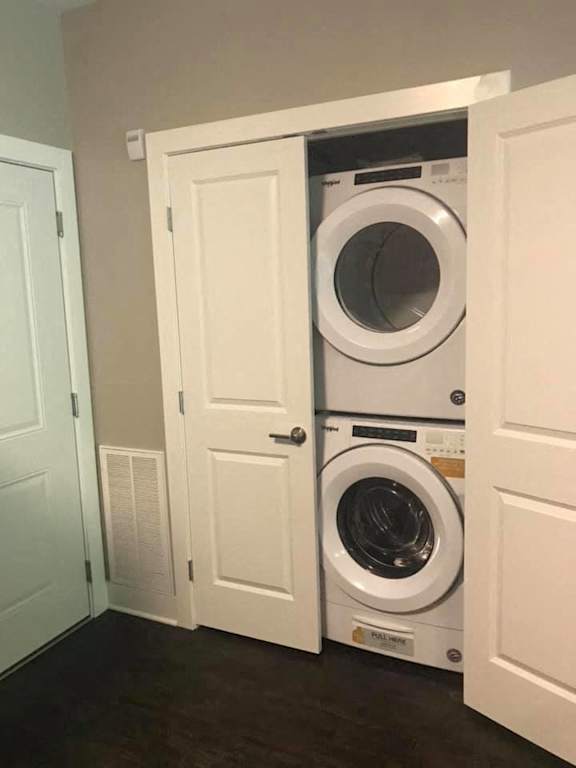 A white door is open to reveal a washing machine inside.