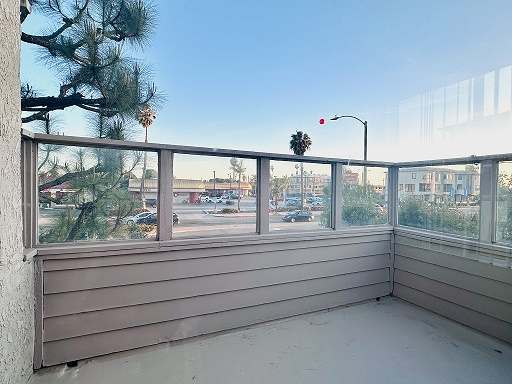 A balcony with a view of a street and buildings.