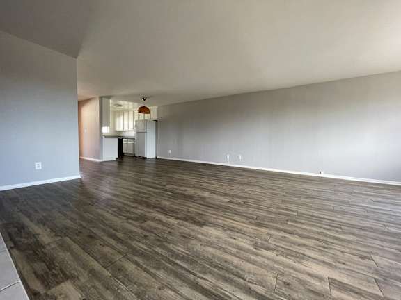 A room with hard wood inspired vinyl flooring and white walls