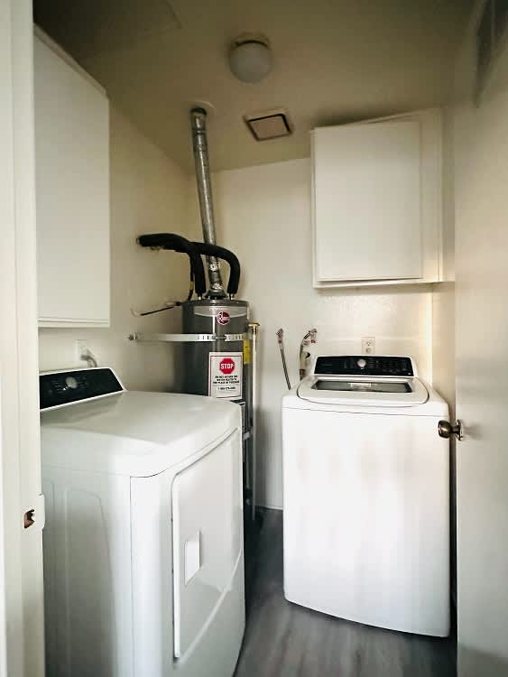A small laundry room with a washer and dryer.