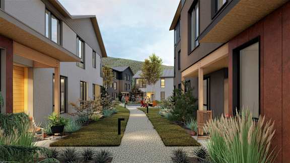 A modern residential area with a pathway and houses on either side.