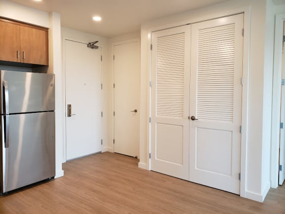 a kitchen with white doors and a stainless steel refrigerator at Connect, San Luis Obispo, California