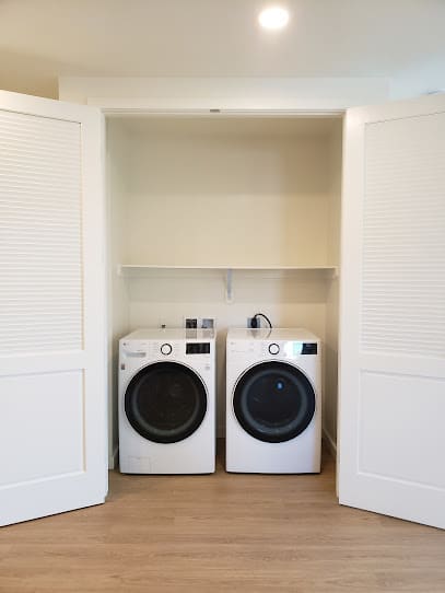 a bathroom with a washer and a dryer in it  at Connect, California