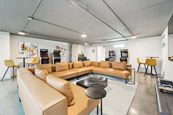 A modern living room with a tan sofa set and a coffee table at The Box, Richmond, VA, 23224