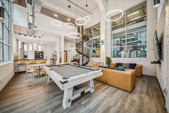 A room with a pool table and a spiral staircase at The Locks, Virginia, 23219