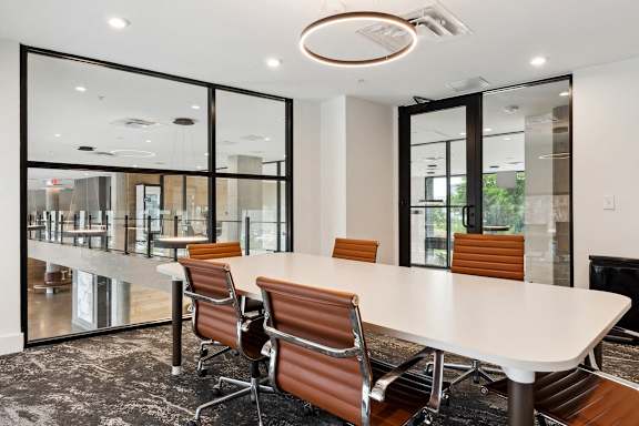 a conference room with a white table and chairs at Hydro, Richmond, VA